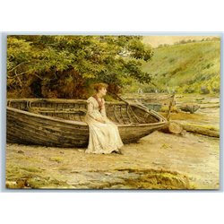 Young Lady sits on a boat on the beach by George Goodwin NEW Modern Postcard